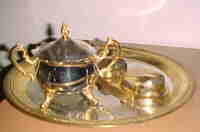 Silver plated antique tea set that had its accents gold plated too